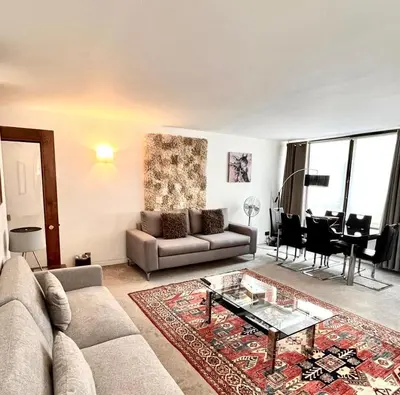 a living room with a couch and a table at Mayfair Piccadilly Apartemnt - 3 in Moffat