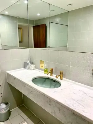 a bathroom with a sink and a large mirror at Mayfair Piccadilly Apartemnt - 3 in Moffat