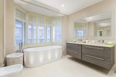 a bathroom with a tub and a toilet and a sink at Luxury 2BR Park Lane Apartment Mayfair Sleeps 6 PL15B in Moffat