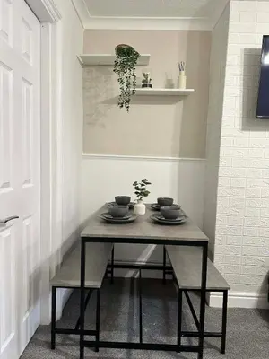 a table in a room with a table and chairs at Comfortable Stay with Free Parking in Cleator