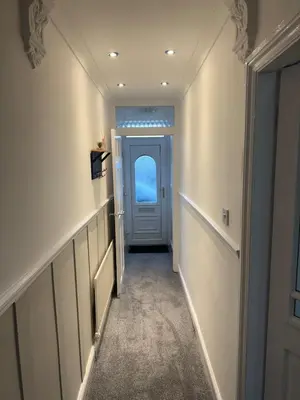 a hallway with a door leading to a hallway with a hallwayngth at Comfortable Stay with Free Parking in Cleator