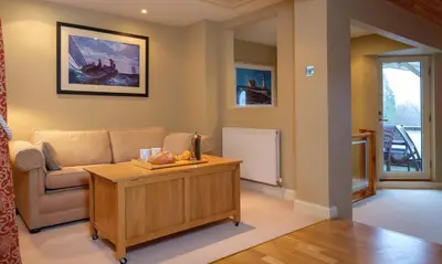 a living room with a couch and a table at Underscar - Scafell in Applethwaite