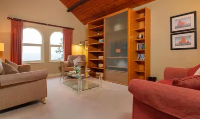 a living room with couches and a glass table at Underscar - Scafell in Applethwaite
