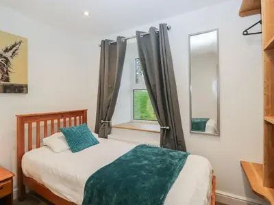 a bedroom with a bed and a window at 6 Hallin Fell in Watermillock