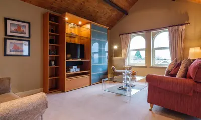 a living room with a glass table and a couch at Watendlath in Applethwaite