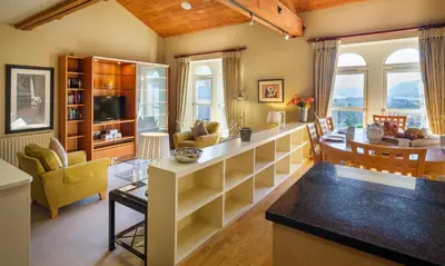 a living room with a kitchen and a dining room at Underscar - Hindscarth in Applethwaite