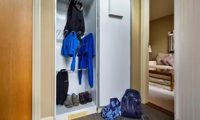 a walk in closet with shoes and a mirror at Catbells in Applethwaite