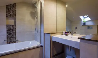 a bathroom with a tub and a sink and a shower at Catbells in Applethwaite