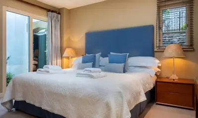 a bedroom with a large bed with towels on it at Brackenburn in Applethwaite