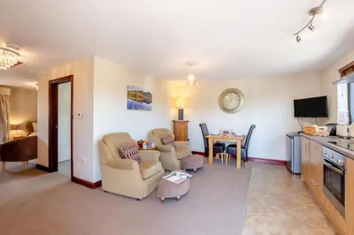 a living room with two chairs and a table at 1 Bed in Isel oc-b32075 in Sunderland