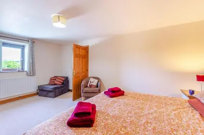 a bedroom with a large bed with red pillows on it at 3 Bed in Isel oc-o32074 in Sunderland