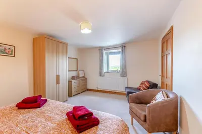 a bedroom with a bed and a couch and a chair at 3 Bed in Isel oc-o32074 in Sunderland