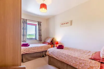 a bedroom with two beds and a window at 3 Bed in Isel oc-o32074 in Sunderland