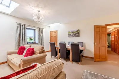 a living room with a table and chairs at 3 Bed in Isel oc-o32074 in Sunderland