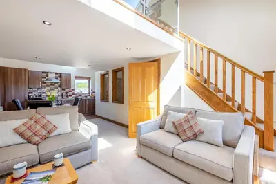 a living room with two couches and a staircase at 2 Bed in Isel oc-s32076 in Sunderland
