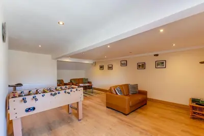 a living room with a foosball table and chairs at 2 Bed in Isel oc-s32076 in Sunderland