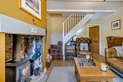 a living room with a fireplace and a chess board at 2 Bed in Rowrah oc-s32232 in Rowrah