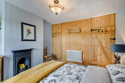 a bedroom with a bed and a fireplace at 2 Bed in Rowrah oc-s32232 in Rowrah