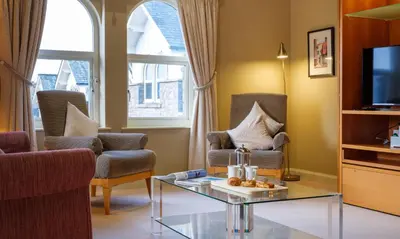 a living room with two chairs and a coffee table at Grisedale in Applethwaite