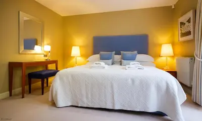 a bedroom with a large white bed with towels on it at Underscar - High Spy in Applethwaite