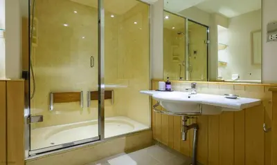a bathroom with a sink and a shower and a tub at Underscar - High Spy in Applethwaite