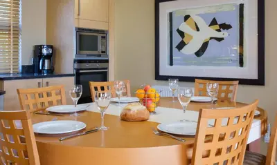 a dining room table with plates and wine glasses at Underscar - Seatoller in Keswick