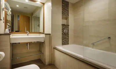 a bathroom with a tub and a sink and a toilet at Underscar - Seatoller in Keswick