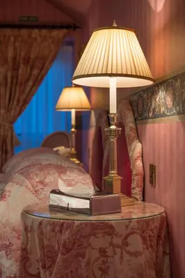 a lamp on a table next to a bed at Regency Hotel in Douglas