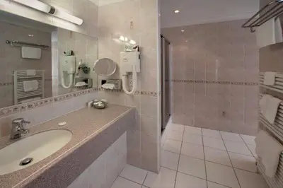 a bathroom with a sink and a shower at Regency Hotel in Douglas