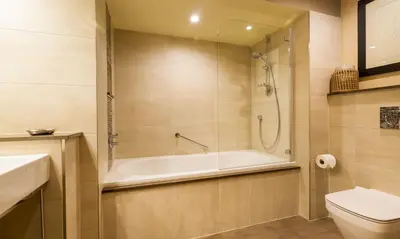 a bathroom with a bath tub and a toilet at Underscar - Whinlatter in Keswick