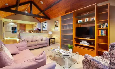 a living room with two couches and a tv at Underscar - Whinlatter in Keswick