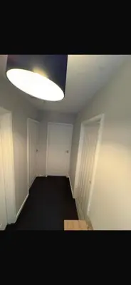 an empty room with a light on the ceiling at Beautiful modern self-contained house in Moffat