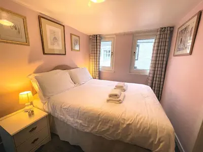 a small bedroom with a bed and a window at Cosy Cottage in Moffat Town Centre - Pass the Keys in Moffat