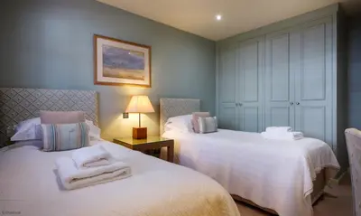 a bedroom with two beds with towels on them at Underscar - Great Gable in Keswick