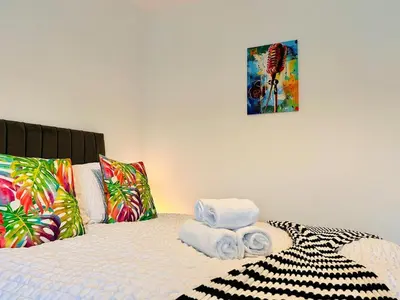 a bedroom with a bed with towels on it at Vulcan Apartment - 3 Bedrooms - Sleeps 6 in Workington