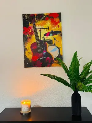 a painting of a guitar and a plant on a table at Vulcan Apartment - 3 Bedrooms - Sleeps 6 in Workington