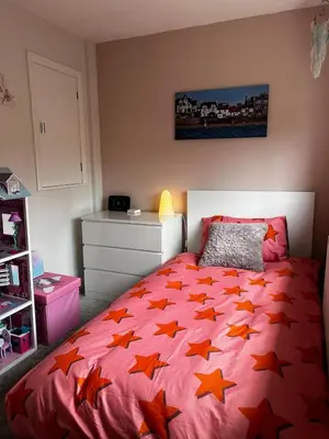 a bedroom with a bed with orange stars on it at The Beach View - Greenan in Ayr