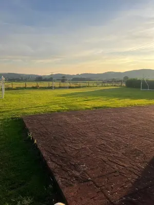 an empty field with a soccer field in the distance at Rural luxury bungalow in Terreglestown