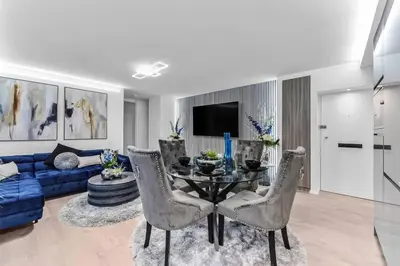 a living room with a table and a blue couch at Luxury 1 Bed near Hyde Park and Marble Arch in Moffat