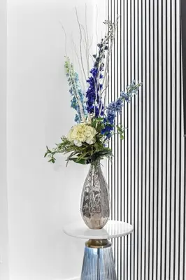 a vase filled with flowers sitting on a table at Luxury 1 Bed near Hyde Park and Marble Arch in Moffat