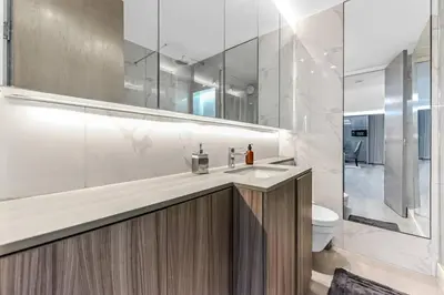 a bathroom with a sink and a toilet and a mirror at Luxury 1 Bed near Hyde Park and Marble Arch in Moffat