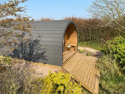 a small house with a wooden deck in a garden at The Eden Hideaway - Uk1554 in Rockcliffe