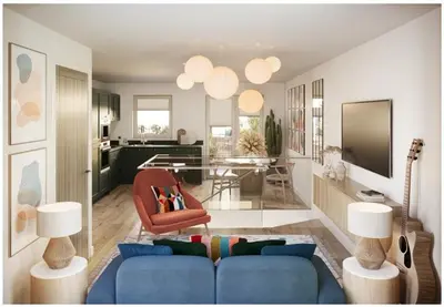 a living room with a blue couch and a dining room at The Beach House in Moffat