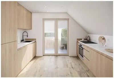a kitchen with wooden cabinets and a large window at The Beach House in Moffat