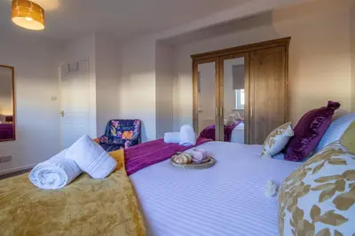 a bedroom with two beds with towels on them at The Bridge- 3 Bedrooms in Coatbridge with Driveway in Moffat