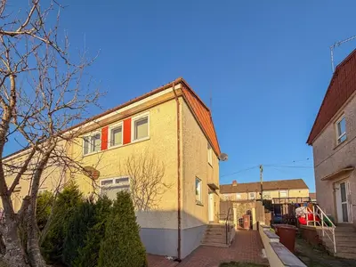 a yellow house with red windows on a street at The Bridge- 3 Bedrooms in Coatbridge with Driveway in Moffat