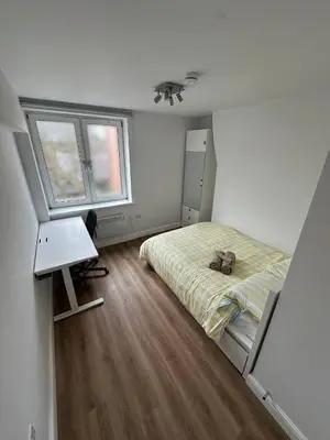 a bedroom with a bed and a desk and a window at 3x Large Double bedroom, Central London flat in Moffat