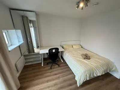 a small bedroom with a bed and a desk at 3x Large Double bedroom, Central London flat in Moffat