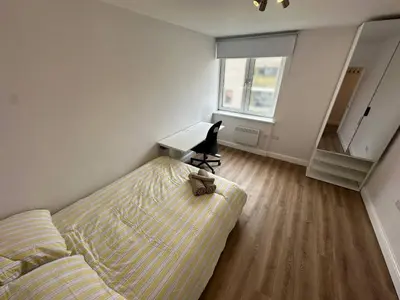 a living room with a couch and a desk at 3x Large Double bedroom, Central London flat in Moffat