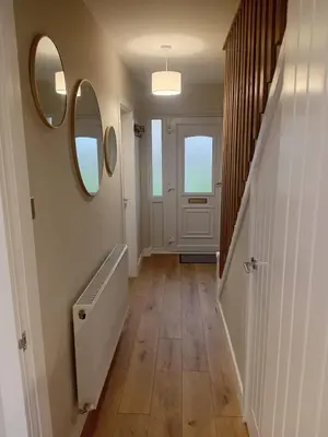 a hallway with two mirrors on the wall and a door at Martindale Close - 3 Bedrooms - Sleeps 5 in Whitehaven